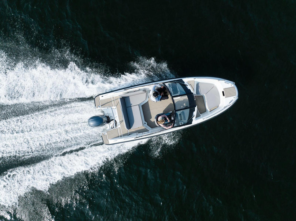 Aerial view of Yamarin 59 BR power boat on the water, showcasing its sleek design and compact size from above.