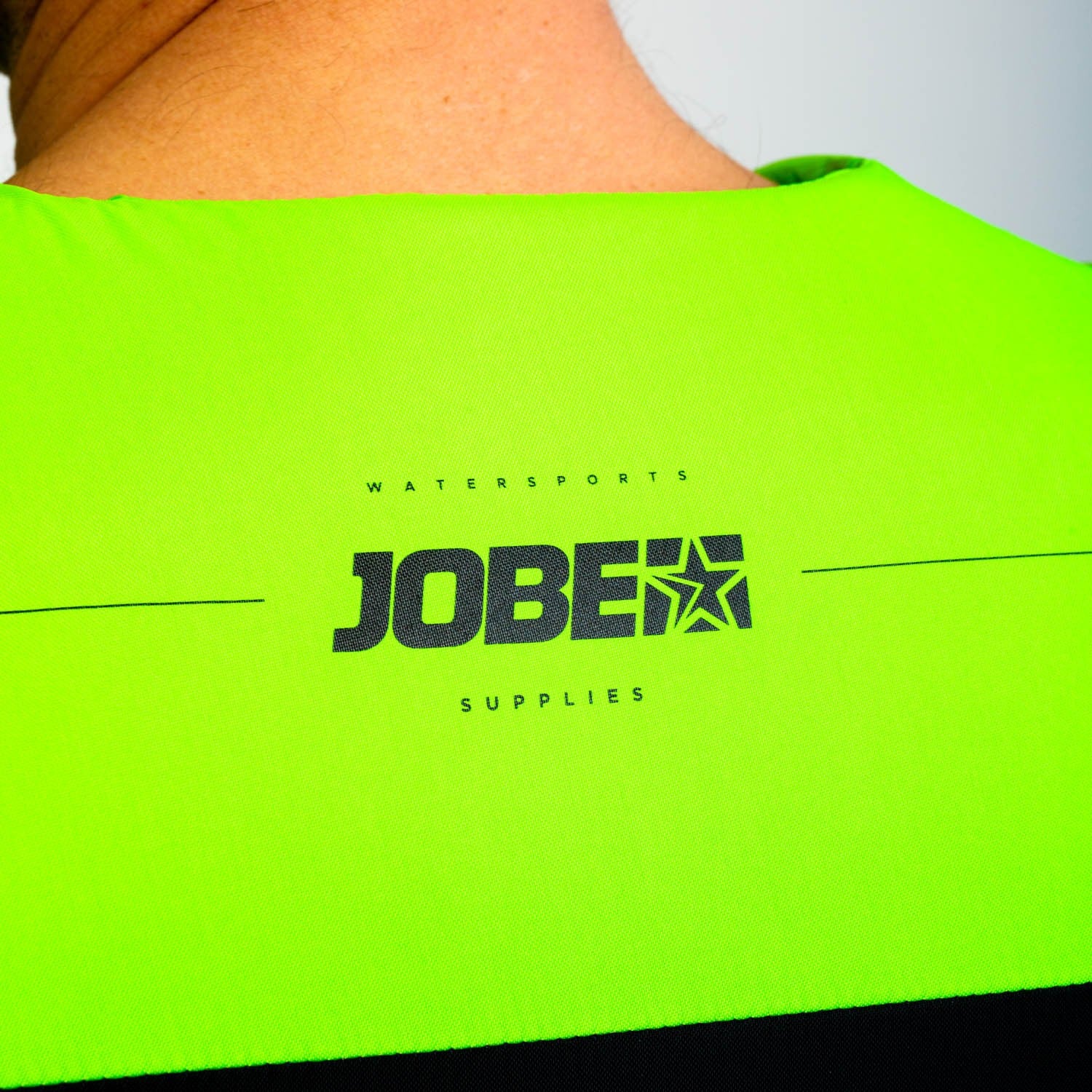 Jobe Dual Vest in lime green for water sports, featuring adjustable straps and buoyant design for safety and comfort.