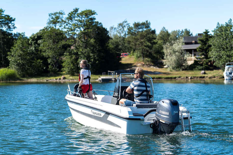 Yamarin 46SC power boat in a calm lake setting, showcasing its sleek design and spacious deck.